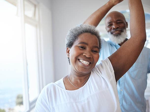 Couple smiling with confidence after restorative dental care